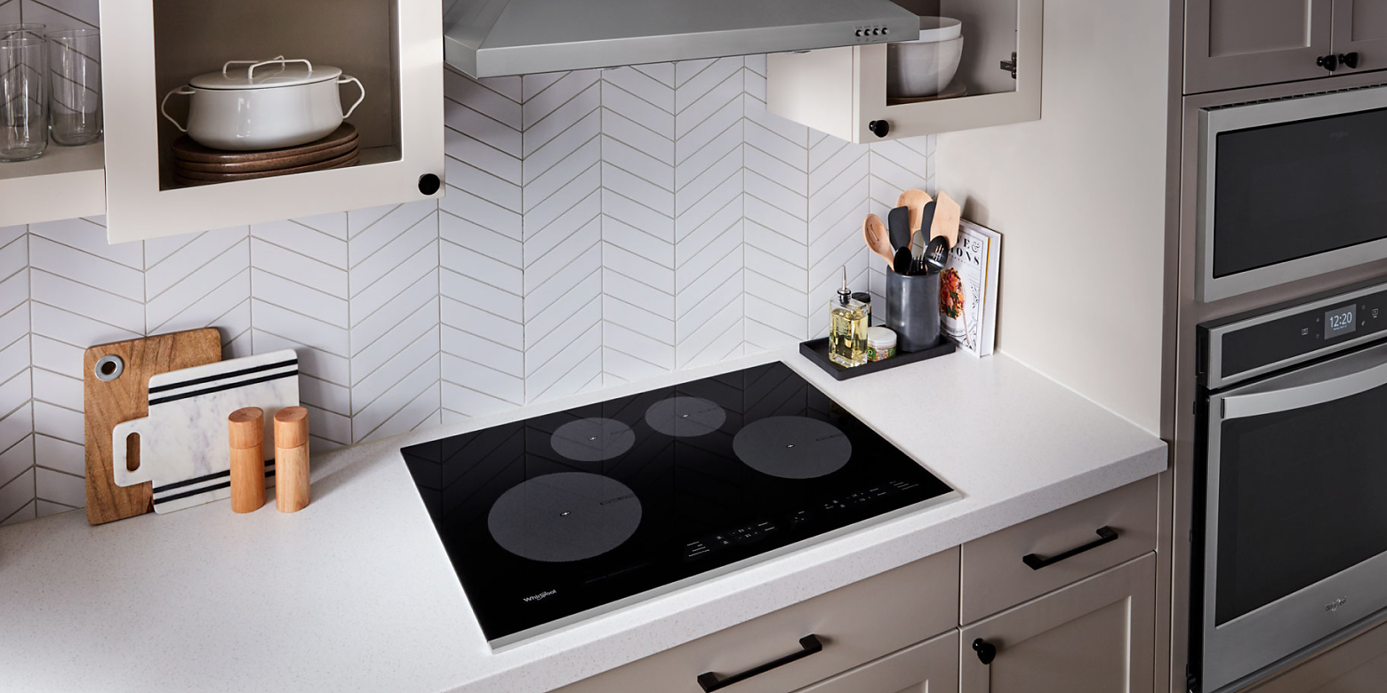 A black 4-burner ceramic glass cooktop.