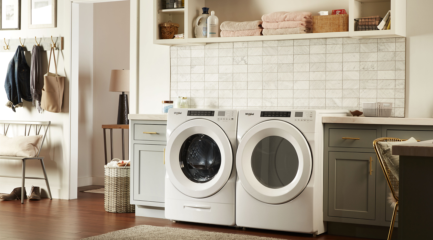 A laundry room featuring a Whirlpool® washer and dryer