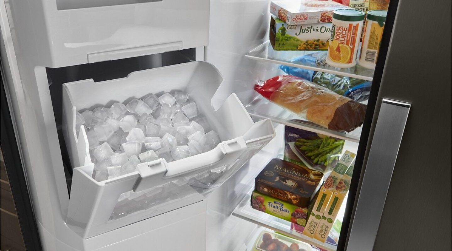 A Whirlpool® refrigerator with an open ice box.