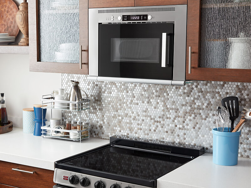 Whirlpool® over-the-range microwave installed above an electric cooktop