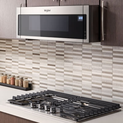 Whirlpool® low profile over-the-range microwave above a gas cooktop
