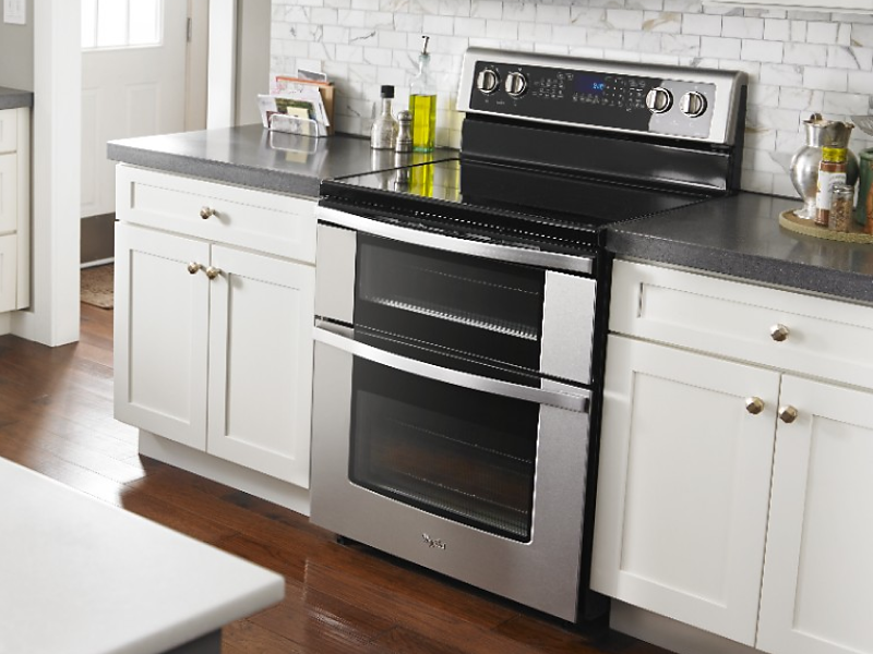 A stainless steel double oven freestanding range in a modern kitchen