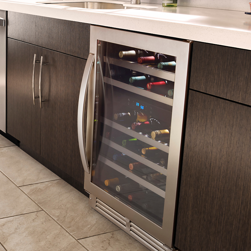 An undercounter wine fridge installed in a kitchen