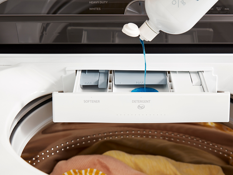 Detergent pouring into a Whirlpool® detergent dispenser