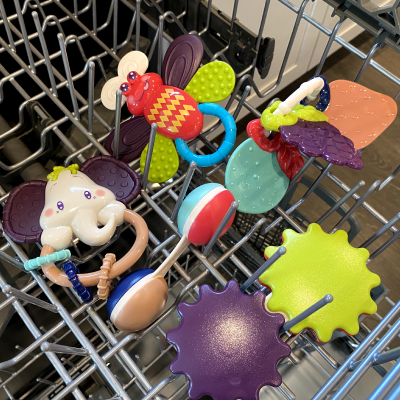Kids toys and accessories on the top rack of a dishwasher