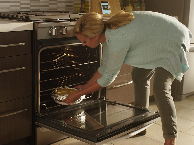 Person placing food in an oven