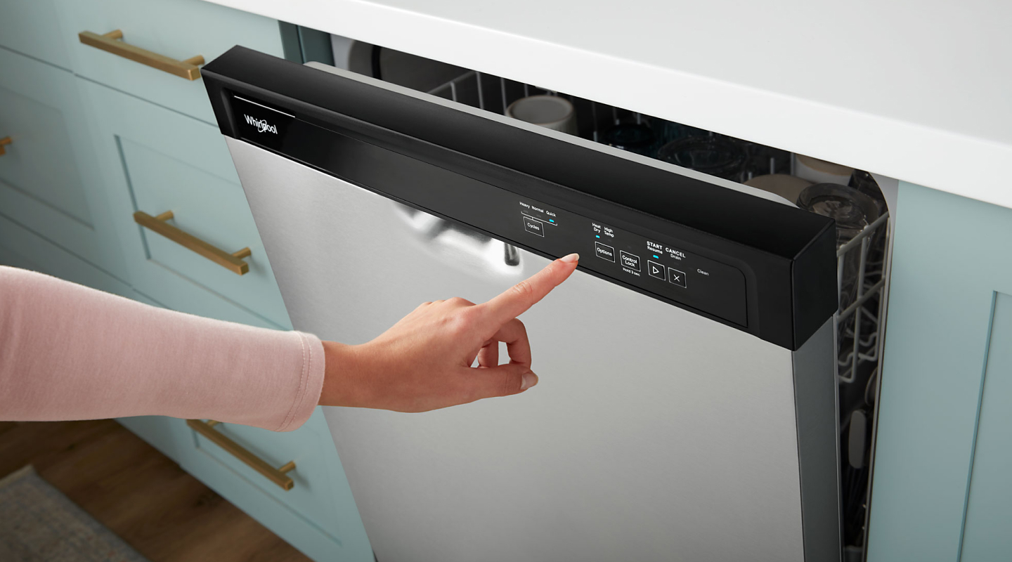 Person pushing button on front control dishwasher
