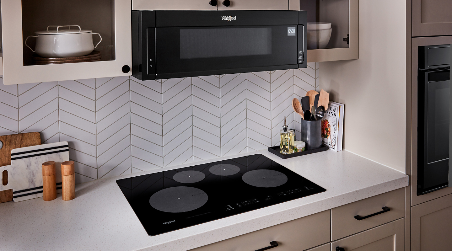 Black Whirlpool® electric cooktop in a modern kitchen