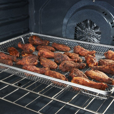 Chicken wings cooking in an air fry oven