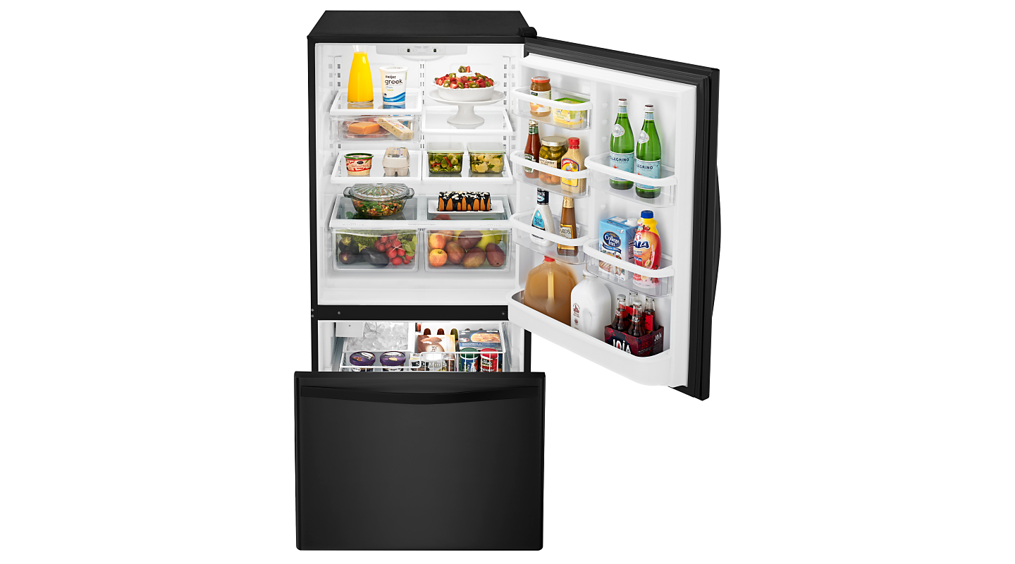 Open bottom-freezer refrigerator with food inside