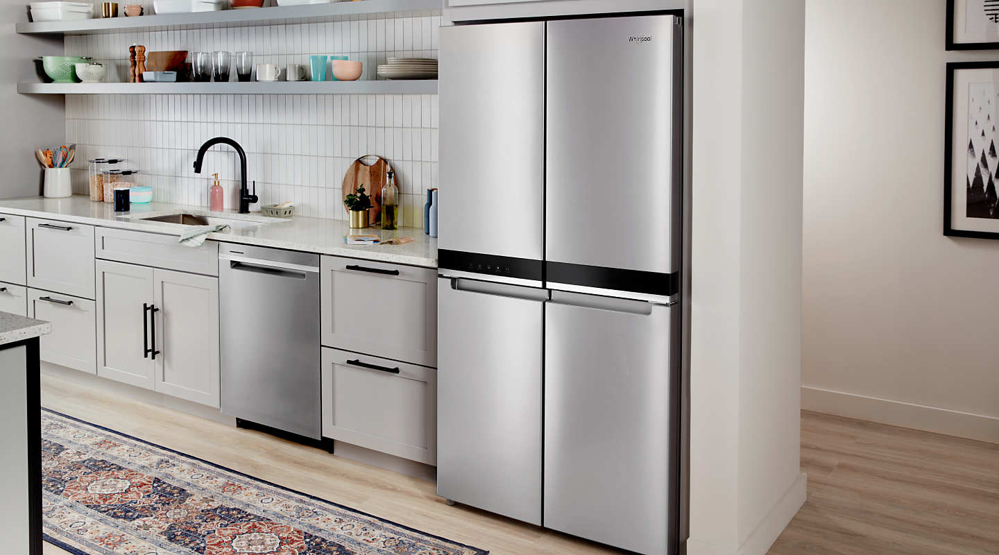 Stainless steel four-door refrigerator set in white cabinetry