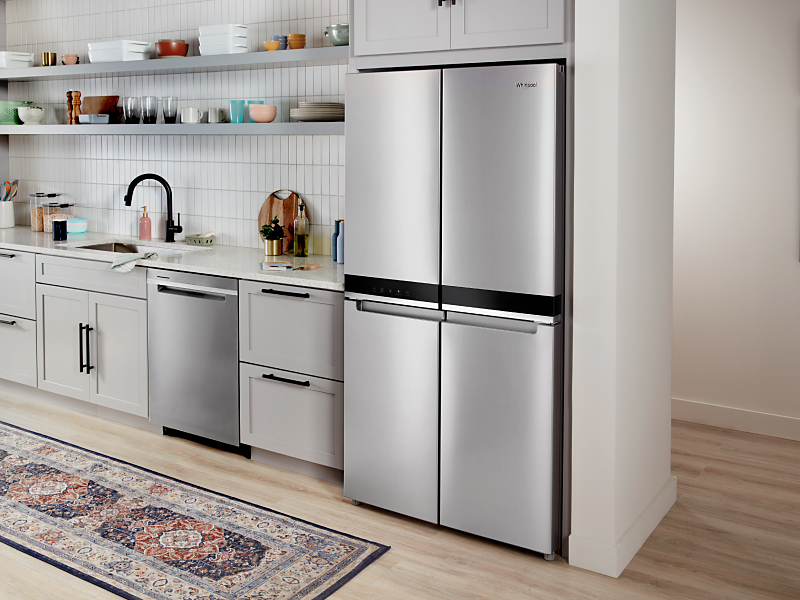 Stainless steel four-door refrigerator set in white cabinetry