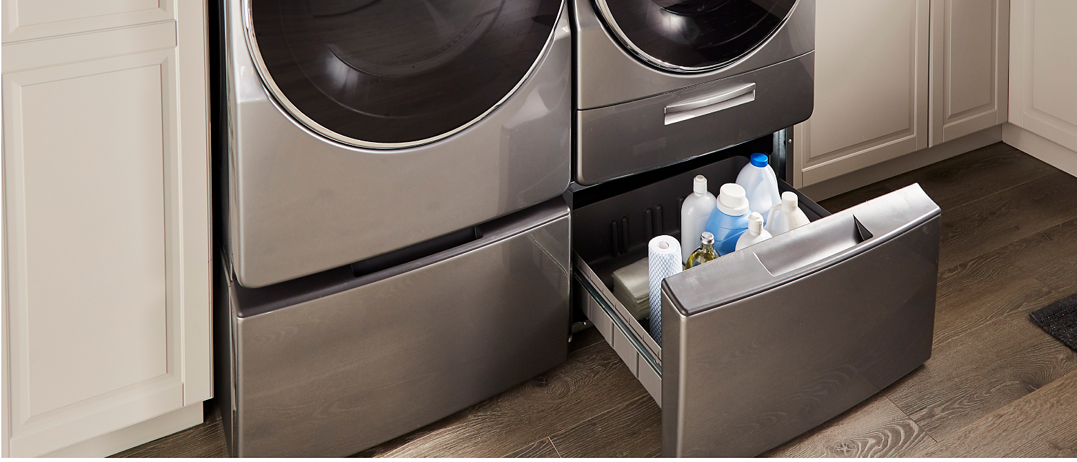 A Whirlpool® Laundry Pedestal drawer filled with laundry supplies
