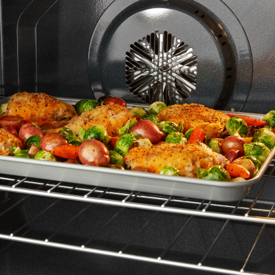 Food cooking on a sheet pan in the oven