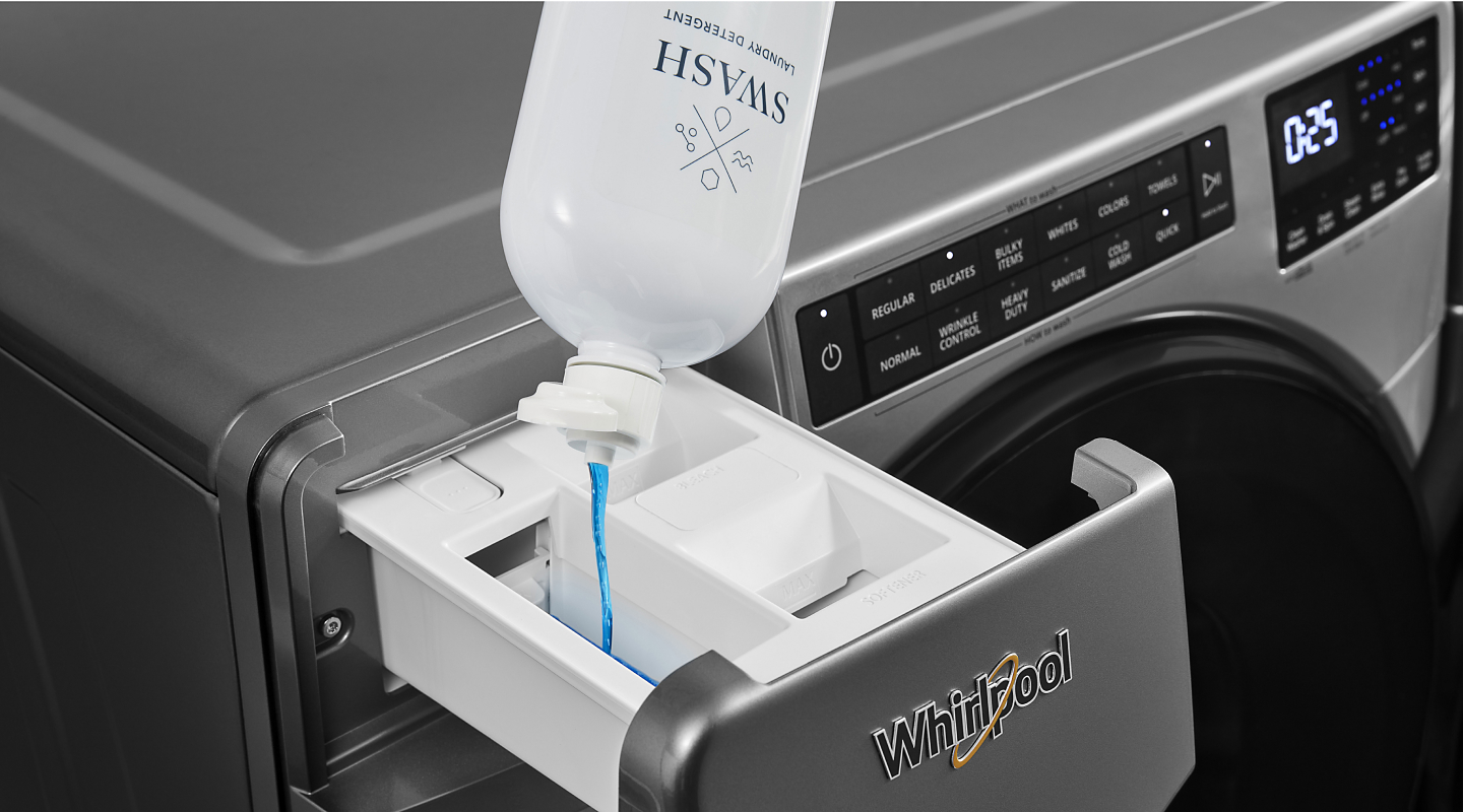 Swash® laundry detergent poured into the dispenser drawer of a Whirlpool® washing machine