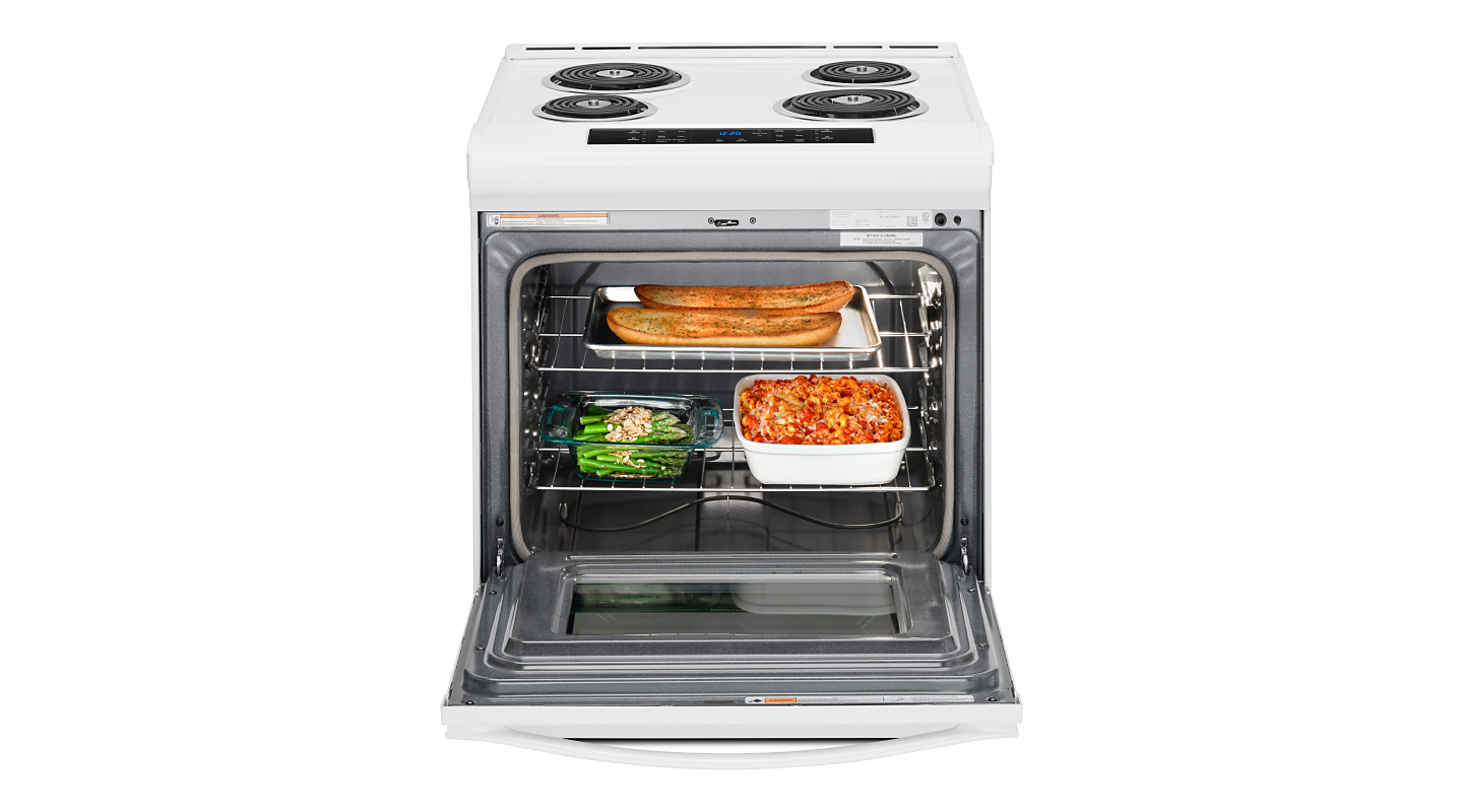 A Whirlpool® white slide-in range with food cooking inside 