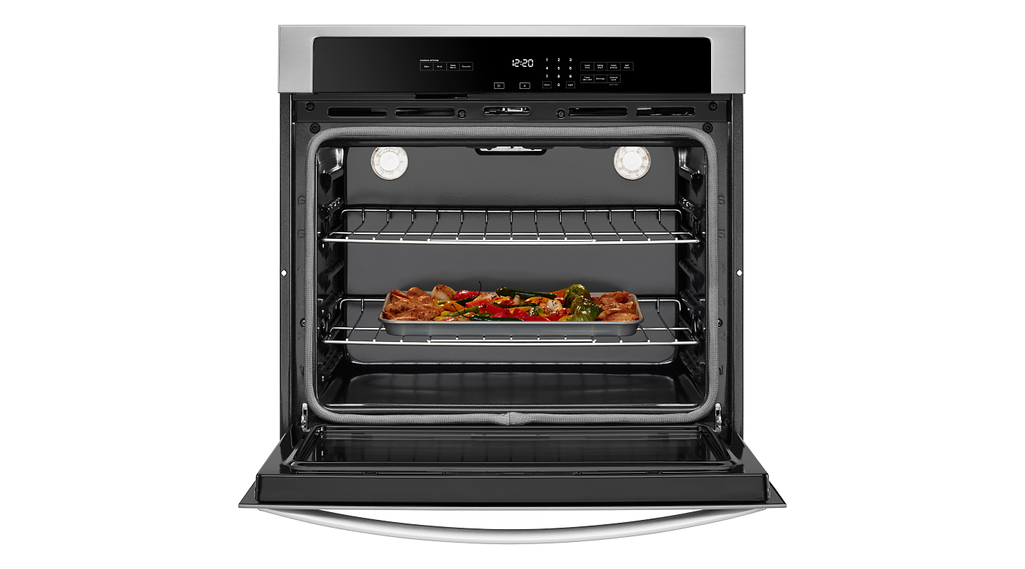 A Whirlpool® wall oven with a baking sheet of food inside