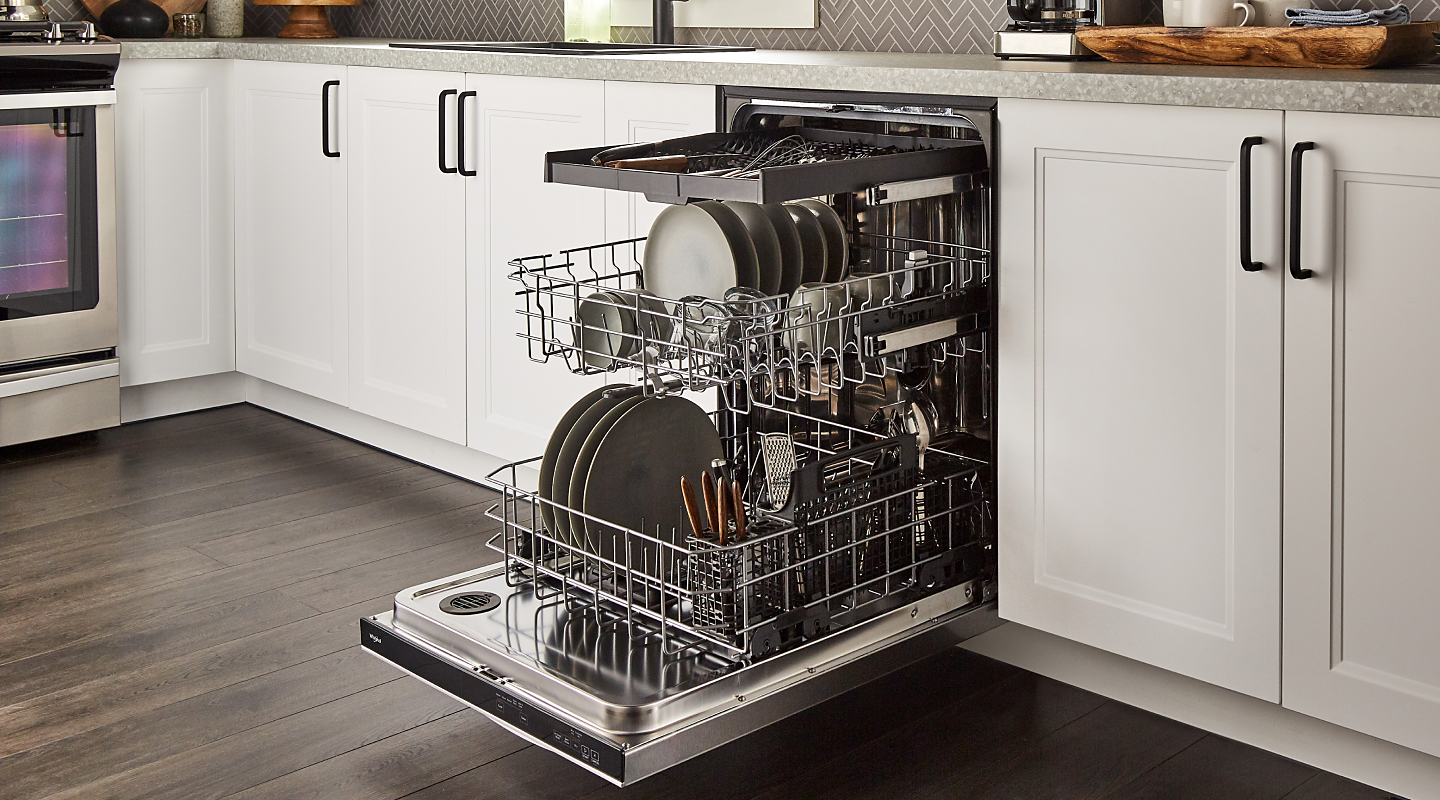  Dishes loaded into a stainless steel 3 rack dishwasher 