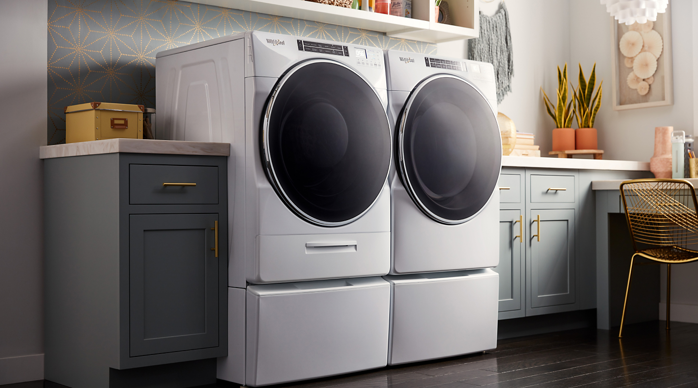 White front-load washer and dryers in a laundry room