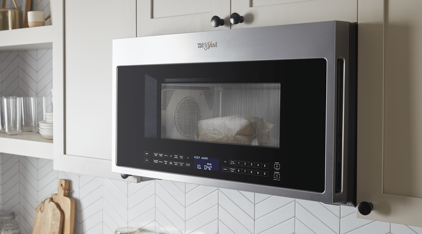 A Whirlpool® Over-The-Range Microwave in a modern kitchen. 