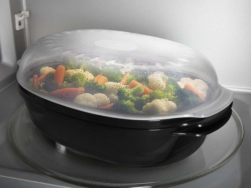 A tray of vegetables inside a microwave.