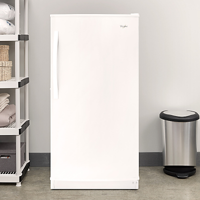 A white Whirlpool® All Refrigerator in a laundry room