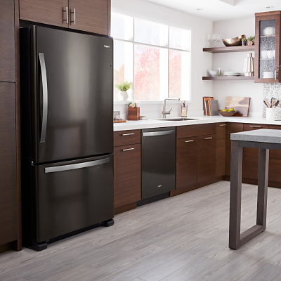 A black Whirlpool® Bottom-Freezer Refrigerator in a modern kitchen