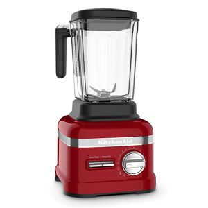 Close-up of red Kitchenaid blender and white Kitchenaid mixer on wooden  worktop below glass-ware on shelves in small kitchen Stock Photo - Alamy