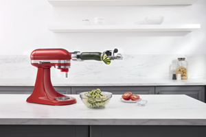 A KitchenAid® stand mixer using the spiralizer attachment.